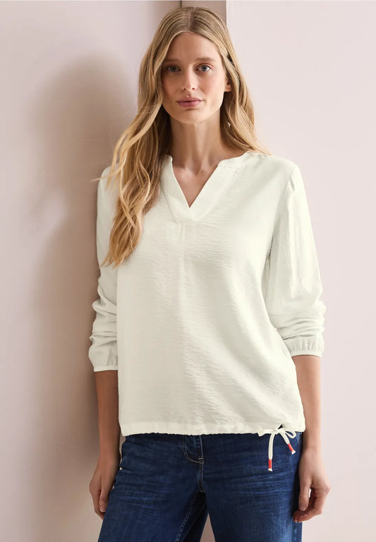 BLUSA MONOCOLOR  CON CORDON EN DOBLADILLO