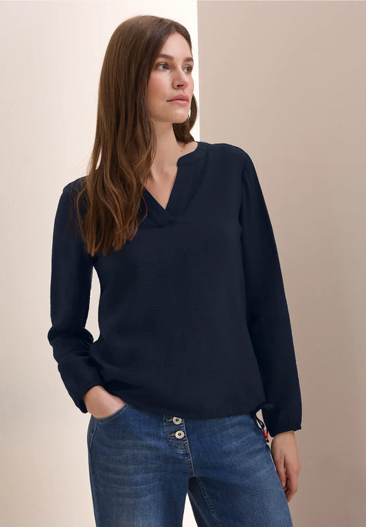 BLUSA MONOCOLOR  CON CORDON EN DOBLADILLO