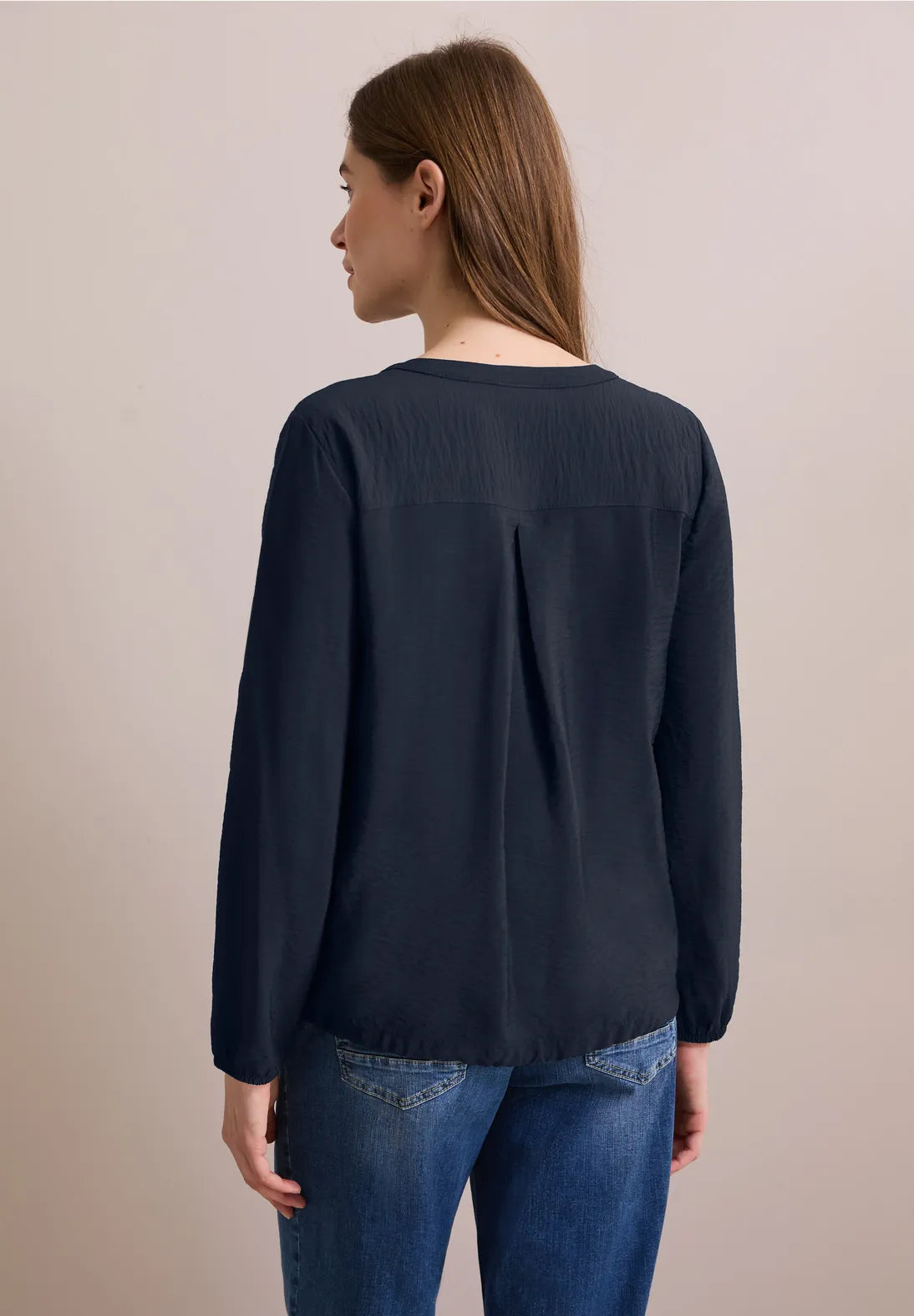 BLUSA MONOCOLOR  CON CORDON EN DOBLADILLO